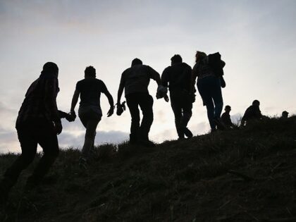 WESLACO, TX - APRIL 13: Undocumented immigrants are led after being caught and handcuffed by Border Patrol agents near the U.S.-Mexico border on April 13, 2016 in Weslaco, Texas. Border security and immigration, both legal and otherwise, continue to be contentious national issues in the 2016 Presidential campaign. (Photo by …