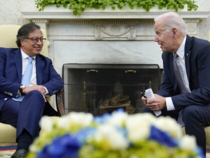 President Joe Biden leans over to speak with Colombian President Gustavo Petro as reporter