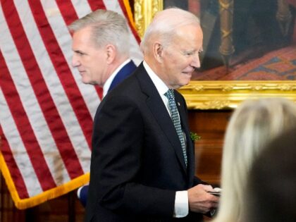 President Joe Biden walks past House Speaker Kevin McCarthy of Calif., after McCarthy introduced him to speak during a Friends of Ireland Caucus St. Patrick's Day luncheon in the U.S. Capitol, Friday, March 17, 2023, in Washington. (AP Photo/Alex Brandon)