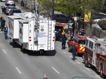 The Louisville metro Police Command Center along with units of the Louisville Fire Department are staged a block from the Old National Bank building in Louisville, Ky., Monday, April 10, 2023. (AP Photo/Timothy D. Easley)