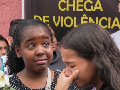 Helloisa Bastos de Carvalho, a student at the Thomazia Montoro public school, left, attend
