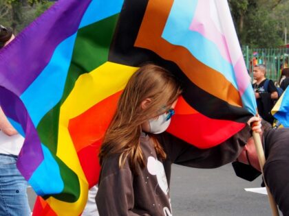 LIMA, PERU - 2022/06/25: A girl waving a LGBT flag when thousands of activists from the LGBT + community and sympathizers took to the Lima downtown streets to participate in the 2022 Peru Pride Parade in search of recognition of their civil rights and against discrimination.