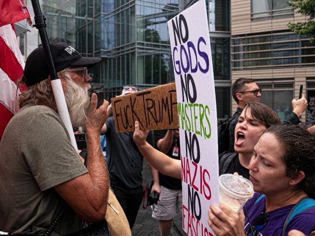 WASHINGTON, DC - JULY 26: Protesters calling for the indictment of Donald Trump (R) argue