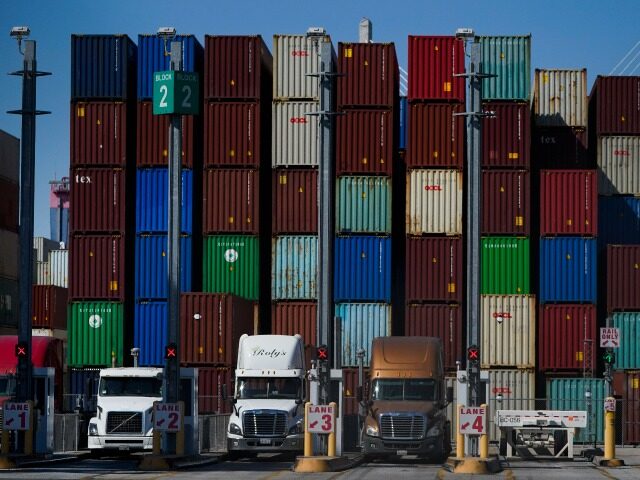 FILE - Containers are stacked at the Port of Long Beach in Long Beach in Calif., Oct. 1, 2
