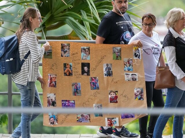 Relatives and friends carry a poster with photos of four-year-old Bernardo Pabst, who was