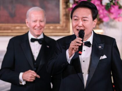 Yoon Suk Yeol, South Korea's president, right, sings during a state dinner with US President Joe Biden, left, at the White House in Washington, DC, US, on Wednesday, April 26, 2023. The US will strengthen the deterrence it provides South Korea against nuclear threats, securing a pledge from Seoul to …