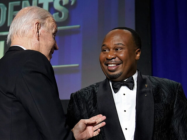 President Joe Biden shakes hands with comedian Roy Wood Jr., a correspondent for "The Dail