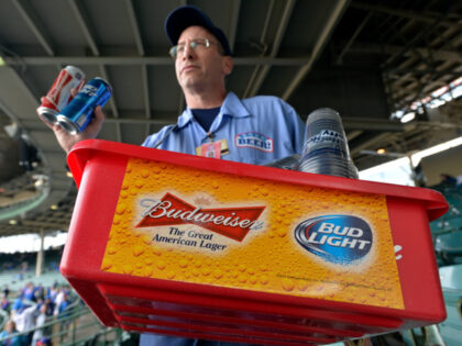 FILE - In this Tuesday, Oct. 13, 2015, file photo, a beer vender holds up Budweiser and Bu