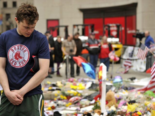 A man visits a make-shift memorial on Boylston Street on April 20, 2013, near the scene of