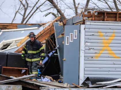 SULLIVAN, INDIANA, UNITED STATES - 2023/04/01: A firefighter helps with search and rescue operations after a tornado in Sullivan, Indiana. Three people were declared dead, and 8 others were injured, as the search and rescue operation continued Saturday afternoon. The severe storm that created the tornado struck Friday, March 31, …