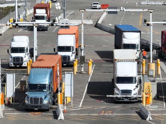 OAKLAND, CALIFORNIA - MARCH 31: In an aerial view, trucks line up to leave a shipping term