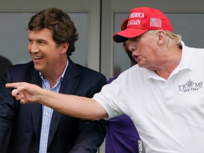 Tucker Carlson, left, and former President Donald Trump, talk while watching golfers on the 16th tee during the final round of the LIV Golf Invitational at Trump National in Bedminster, N.J., July 31, 2022. A defamation lawsuit against Fox News is revealing blunt behind-the-scenes opinions by its top figures about …