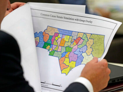 FILE - In this July 26, 2017, file photo, a lawmaker studies a district map during a joint select committee meeting on redistricting in Raleigh, N.C. In massive victories for Republicans, the North Carolina Supreme Court on Friday, April 28, 2023, threw out a previous ruling against gerrymandered voting maps …