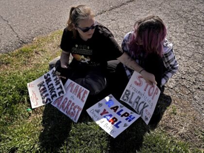Trisha Loftis and her daughter Ashlyn, 13, sit outside the house where 16-year-old Ralph Yarl was shot several days earlier when he went to the wrong address to pick up his brothers, Monday, April 17, 2023, in Kansas City, Mo. (Charlie Riedel/AP)