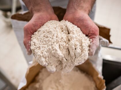 17 April 2019, Hessen, Steinau an der Straße: In his bakery, master baker Jürgen Fink stands by a sack of organic spelt flour that he uses in his breads alongside other regional products. Under the motto "Baking with love and time", the company, which has been family-owned for many generations, …