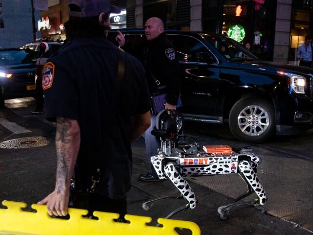 Emergency workers escort a robot dog at the accident site of a partial collapsed parking garage in New York, the United States, on April 18, 2023. One person was killed and five others injured after a parking garage collapsed in Lower Manhattan of New York City on Tuesday afternoon, authorities …