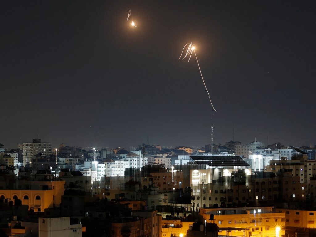 TOPSHOT - Streaks of light are seen as Israel's Iron Dome air defence system intercepts rockets fired from the Gaza Strip into Israeli territory on April 7, 2023. - Israel launched air strikes before dawn on April 7, 2023 in the Gaza Strip and Lebanon, saying it was targeting Hamas in retaliation for several dozen rockets fired at Israel from both territories. The strikes were launched around 4:30 am Israeli time (0130 GMT), hitting both the Gaza Strip and southern Lebanon, according to an Israeli army statement. (Photo by MOHAMMED ABED / AFP) (Photo by MOHAMMED ABED/AFP via Getty Images)