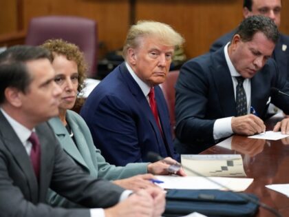 Former President Donald Trump sits at the defense table with his defense team in a Manhatt