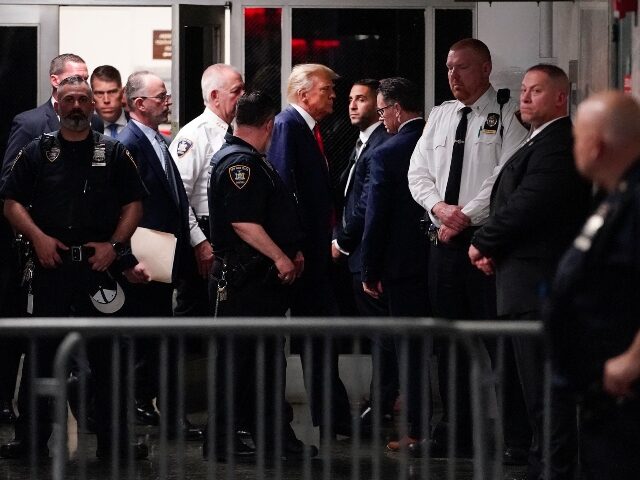Former President Donald Trump is escorted to a courtroom, Tuesday, April 4, 2023, in New York. Trump is set to appear in a New York City courtroom on charges related to falsifying business records in a hush money investigation, the first president ever to be charged with a crime. (AP …