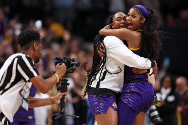 Angel Reese of Louisiana State University celebrates with a teammate after beating Iowa Ha