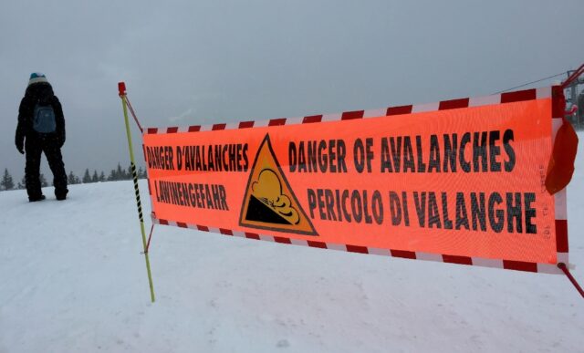 This file photo taken in 2016 in the French Alps shows a banner indicating a high risk of