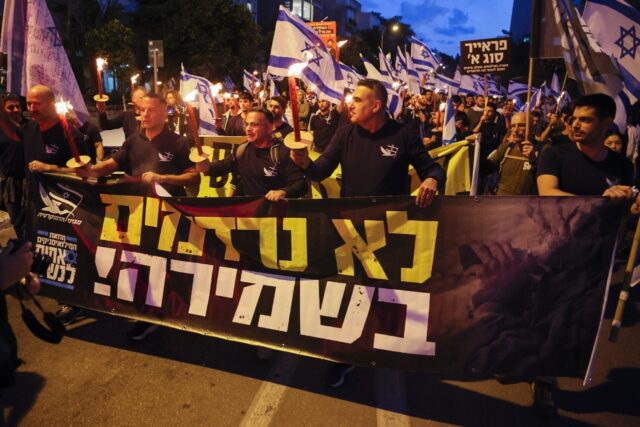 Opponents of the Israeli government's controversial judicial reform plans carry candles as