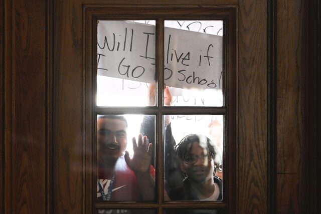 Student protesters hold up a sign during an anti-gun demonstration at the state capitol in
