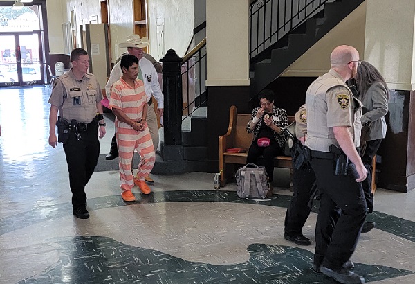 San Jacinto County Sheriff Greg Capers escorts accused killer Francisco Oropesa from a hearing held on May 18 in the courthouse. (Bob Price/Breitbart Texas)