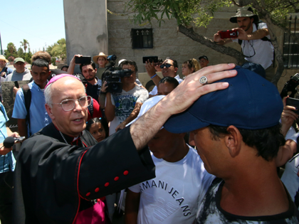 El Paso Catholic Bishop Mark Seitz conducts a blessing on Serafin Aguilera Perez, a Cuban immigrant returned to Mexico while his asylum claim is being processed, during a visit to Juarez, Mexico, across from El Paso, Texas, Thursday, June 27, 2019. Immigrants from Latin American countries and Cuba are currently …