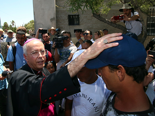 El Paso Catholic Bishop Mark Seitz conducts a blessing on Serafin Aguilera Perez, a Cuban