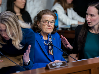 Sen. Dianne Feinstein, D-Calif., is flanked by aides as she returns to the Senate Judiciar