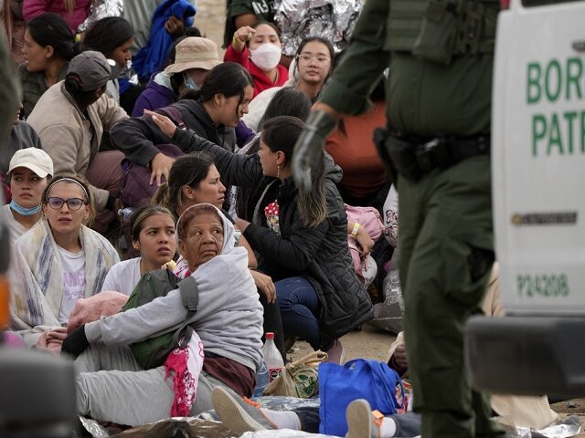 People wait to apply for asylum between two border walls Thursday, May 11, 2023, in San Di