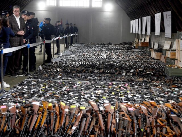In this photo provided by the Serbian Presidential Press Service, Serbian President Aleksandar Vucic, left, inspects weapons collected as part of an amnesty near the city of Smederevo, Serbia, Sunday, May 14, 2023. Serbian authorities on Sunday displayed some of around 13,500 weapons they say have been collected since last …