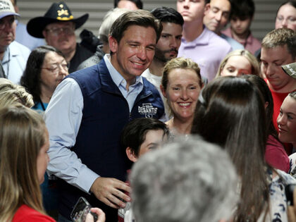 Florida Gov. Ron DeSantis poses for a picture with voters after giving a speech at a rally