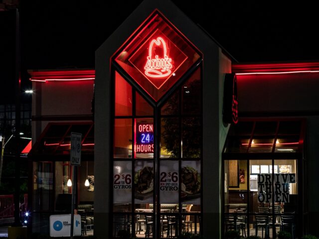 An "Open 24 Hours" sign is illuminated inside an Arby's restaurant in Birmingham, Alabama,