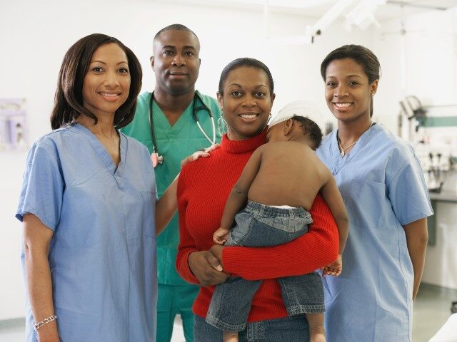 Baby and mother with hospital personnel