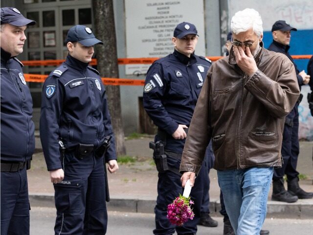BELGRADE, SERBIA - MAY 03: A man reacts as he walks past police officers blocking a street