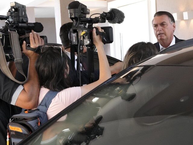 Former Brazilian President Jair Bolsonaro speaks to the press outside his home before gett