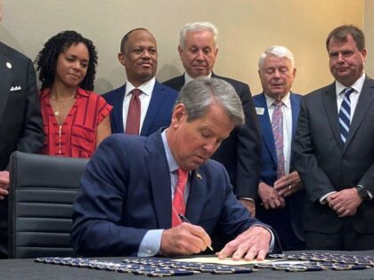 Georgia Gov. Brian Kemp signs into law a bill aimed at making public schools safer during a ceremony in Savannah, Ga., on Thursday, April 13, 2023. The measure requires Georgia schools to hold annual drills on responding to campus shooters. The governor also signed new laws intended to improve literacy …
