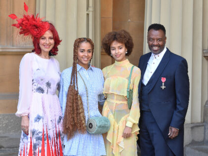 LONDON, ENGLAND - MARCH 14: David Grant wearing his MBE, stands with his wife Carrie and their daughters Olive (second left) and Talia, following an investiture ceremony at Buckingham Palace on March 14, 2019 in London, England. (Photo by John Stillwell - WPA Pool/Getty Images)