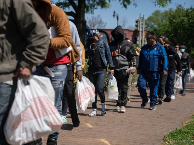 WASHINGTON DC - APRIL 18, 2023 Migrants gather after arriving on a bus from Arizona in Was