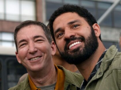 US journalist and author Glenn Greenwald (C) and his partner Brazilian congressman David Miranda (R), pose for selfies with demonstrators during a protest called by intellectuals and artists against the destruction of the Amazon rainforest, at Ipanema Beach in Rio de Janeiro, Brazil, on August 25, 2019. - Brazil on …