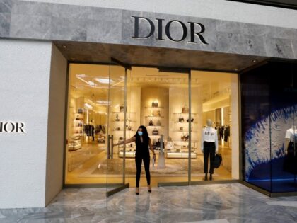 An employee wears a protective mask while opening a Dior store at the Shops & Restaurants at Hudson Yards mall in New York, U.S., Wednesday, Sept. 9th 2020. New York City malls have the green light to reopen Wednesday under the condition that they have enhanced air filtration systems in …