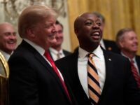 President Donald Trump, second from left, smiles with Sen. Tim Scott, R-S.C., second from right, during a reception for the Clemson Tigers in the East Room of the White House in Washington, Monday, Jan. 14, 2019. (AP Photo/Susan Walsh)