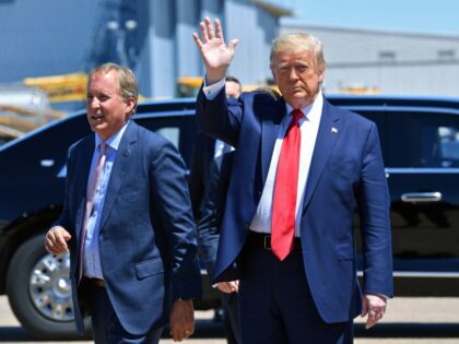President Donald Trump waves upon arrival, alongside Attorney General of Texas Ken Paxton (L) in Dallas, Texas, on June 11, 2020, where he will host a roundtable with faith leaders and small business owners. (NICHOLAS KAMM/AFP via Getty Images)