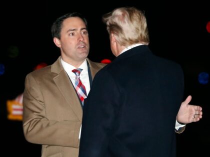 President Donald Trump greets Ohio Secretary of State Frank LaRose Thursday, Jan. 9, 2020, as he arrives at Toledo Express Airport, in Swanton, Ohio, en route to a campaign rally in Toledo, Ohio.