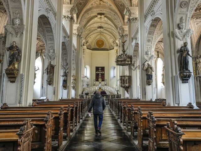 A man walks in the Catholic St. Andreas church in Duesseldorf, Germany, Monday, Feb. 27, 2
