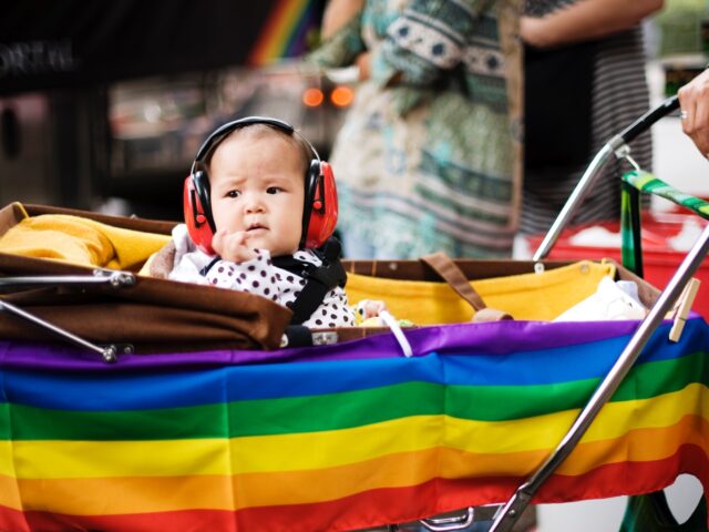 A child with ear-protection gear looks on during the HBTQ festival "Stockholm Pride" parade on August 6, 2011 in central Stockholm. AFP PHOTO / JONATHAN NACKSTRAND (Photo credit should read JONATHAN NACKSTRAND/AFP via Getty Images)