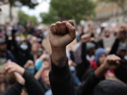 LONDON, ENGLAND - JUNE 03: Protesters raise clenched fists during a Black Lives Matter protest outside the Houses of Parliament on June 3, 2020 in London, United Kingdom. The death of an African-American man, George Floyd, while in the custody of Minneapolis police has sparked protests across the United States, …