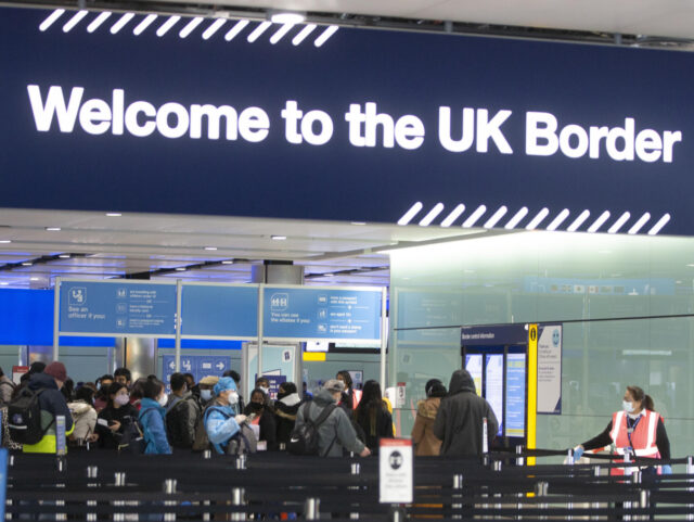 Passengers line up for passport control in the UK Border area of Terminal 2 of Heathrow Ai